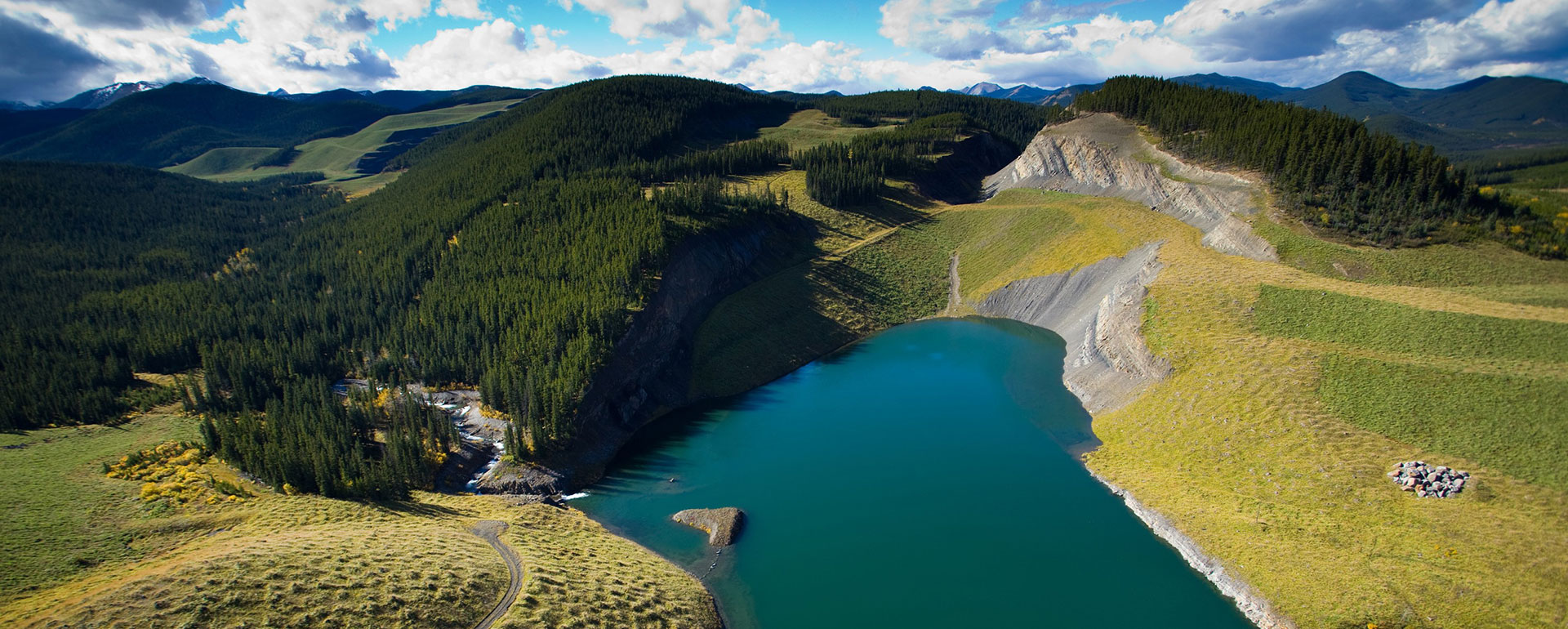 A decommissioned open pit mine that has been turned into a nice lake with greenery around