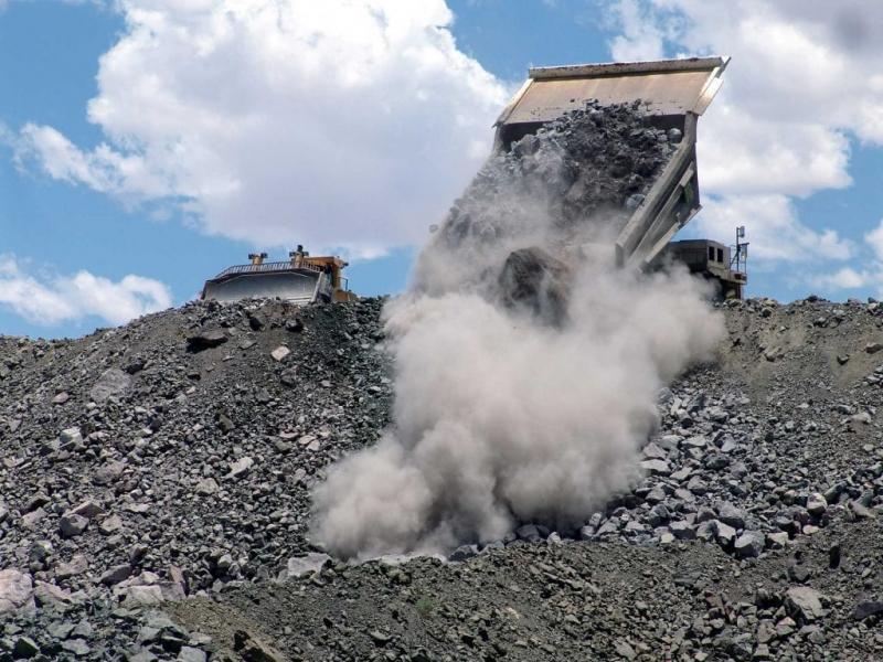 A dump truck depositing excavated material