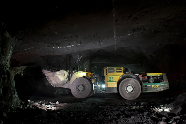 An underground loader moving material inside a tunnel mine